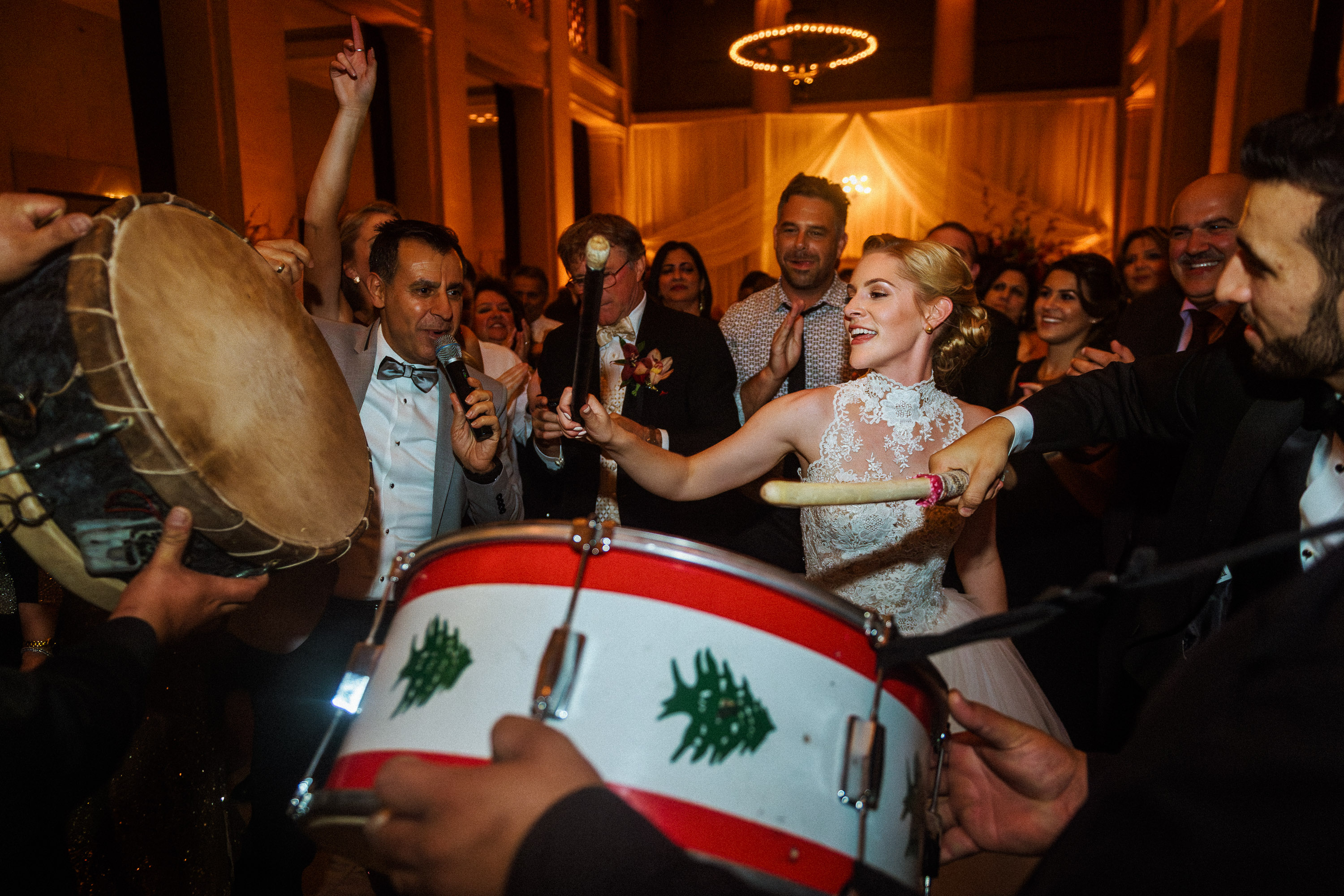Bride playing a drum during a lively Bently Reserve wedding reception