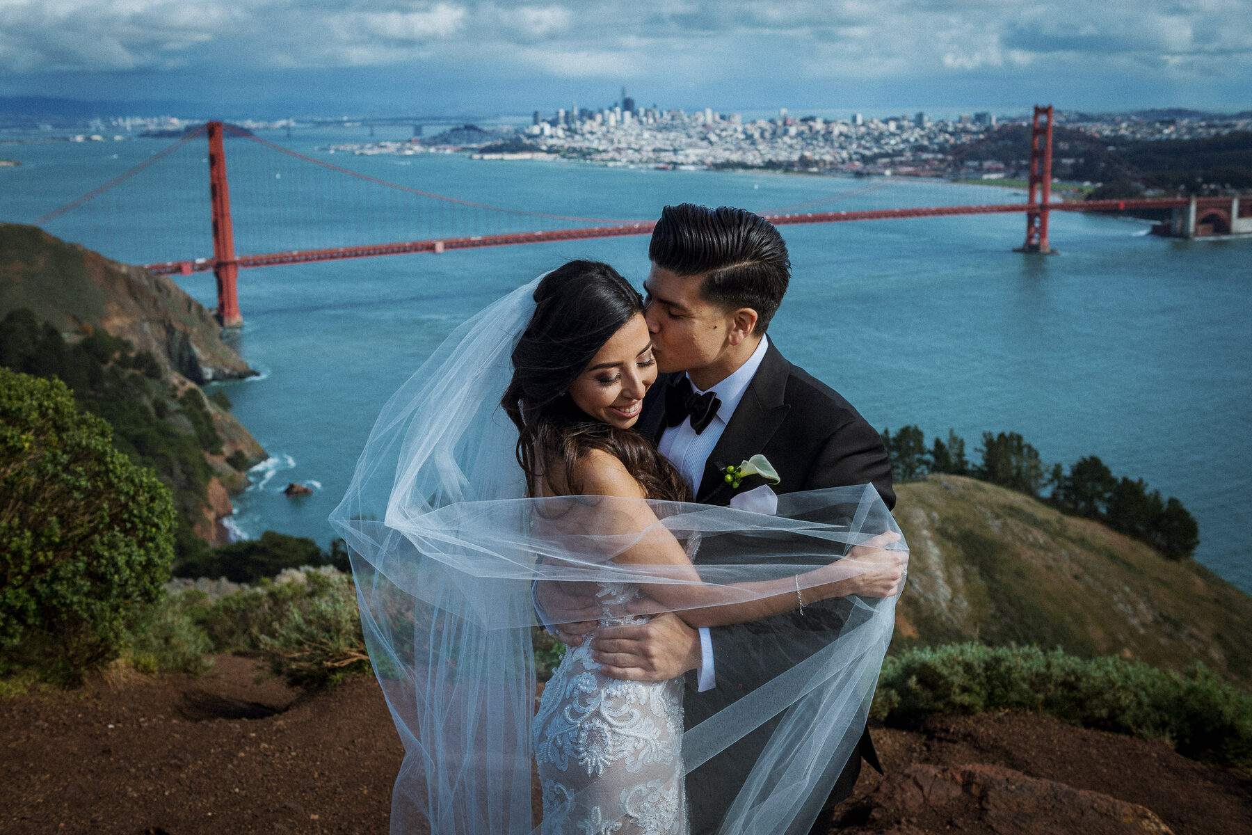Bride and groom overlooking the Golden Gate Bridge after their San Francisco City Hall wedding